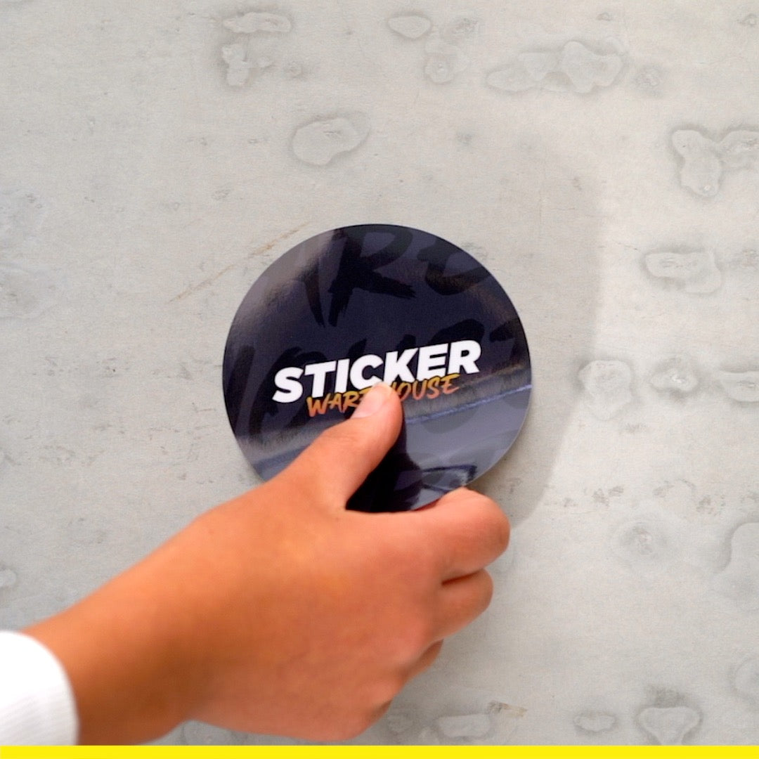 Circle Stickers being applied to a wall, showcasing custom slap sticker from Sticker Warehouse.