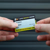 Car Service Stickers held between hands, showcasing customized service details for auto service centers.
